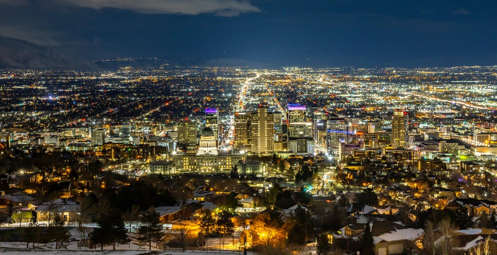 Salt Lake City skyline at night with mountains in the distance